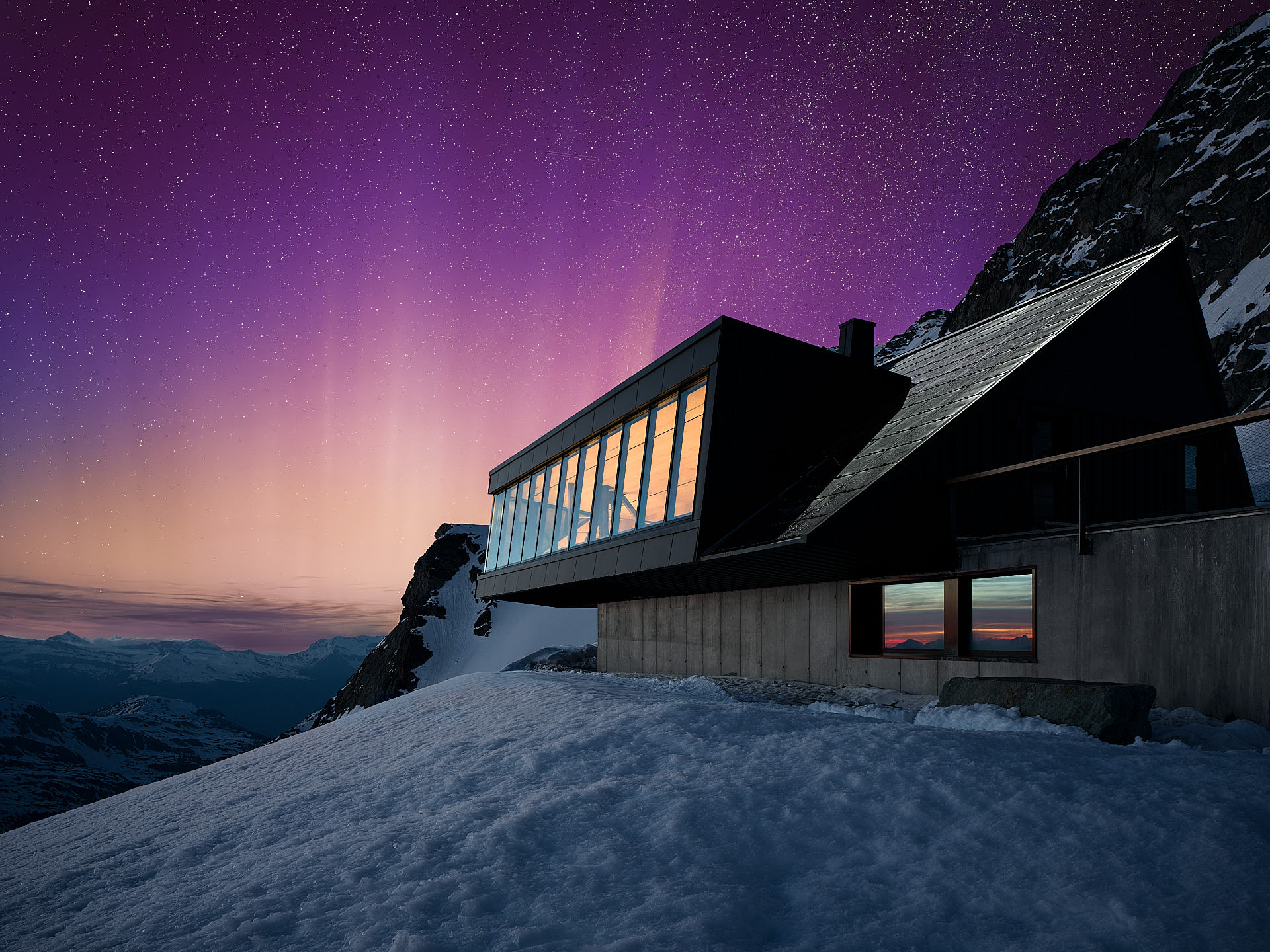 Cabane Tortin exterior glowing warmly at night beneath a canopy of stars and the Milky Way visible above the Alpine peaks